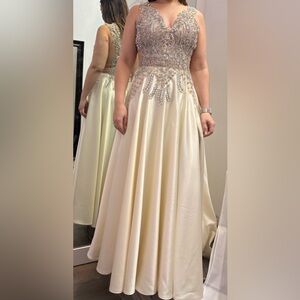 Beautiful custom made dress. Cream with hand stitches crystals and rhinestones.